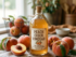 Bottle of peach cider vinegar with fresh peaches on wooden table